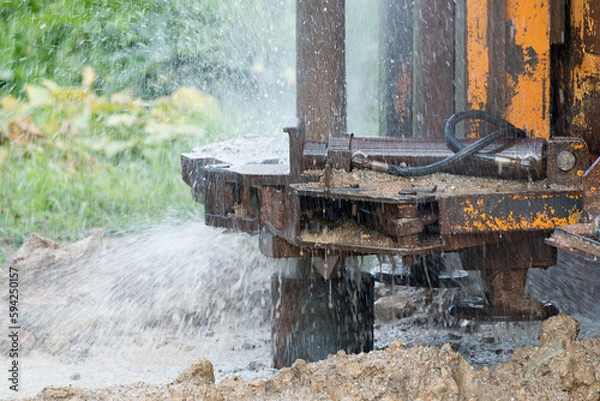 Fototapeta Hope in the Depths: Capturing the Journey of a Water-Seeking Machine in Times of Drought