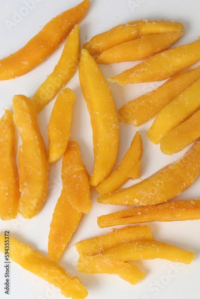 Fototapeta slices of yellow mango closeup photo in plate on white background