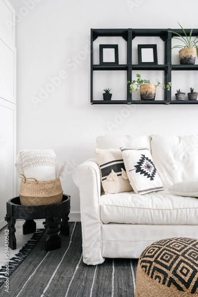Fototapeta living room with white couch and pillows with boho design