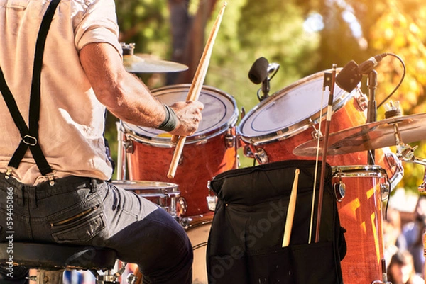 Fototapeta Summer music festival at the park. Close up of drummer playing on the stage