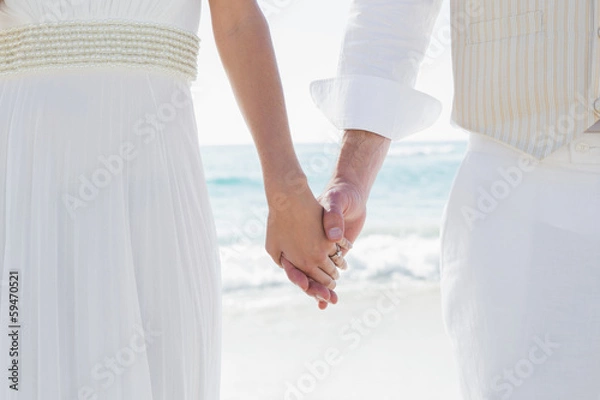Fototapeta Newlyweds holding hands