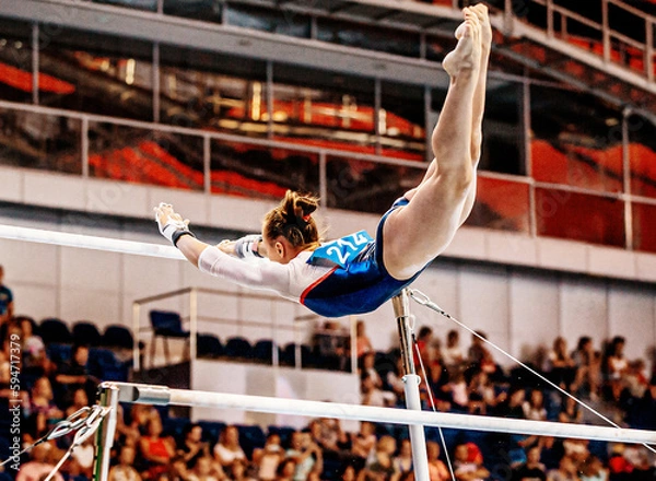 Obraz flight element from low bar to high bar female gymnast exercise on uneven bars in artistic gymnastics