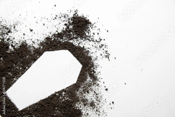 Obraz top view of coffin shape with dark soil on white desk grim reaper funeral death