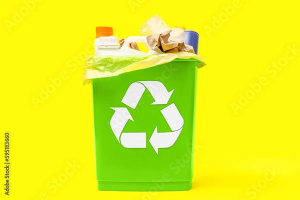 Obraz Trash bin with different garbage on yellow background