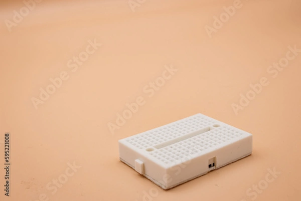 Fototapeta White mini breadboard isolated on background. Close up.