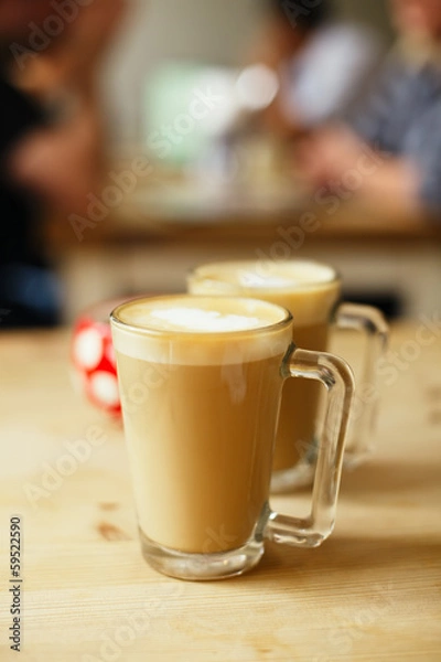 Fototapeta coffee latte in two tall glasses and sugar bowl, shallow dof