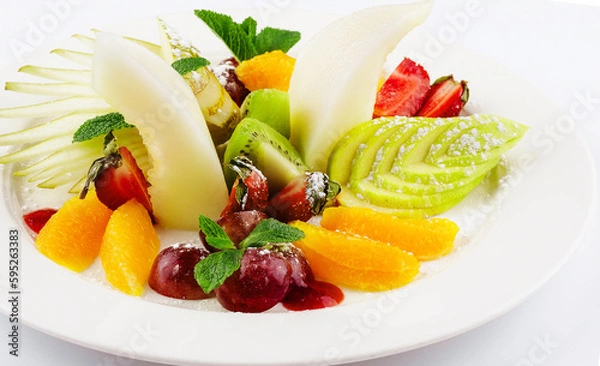 Fototapeta Fresh fruit salad on white plate isolated on white