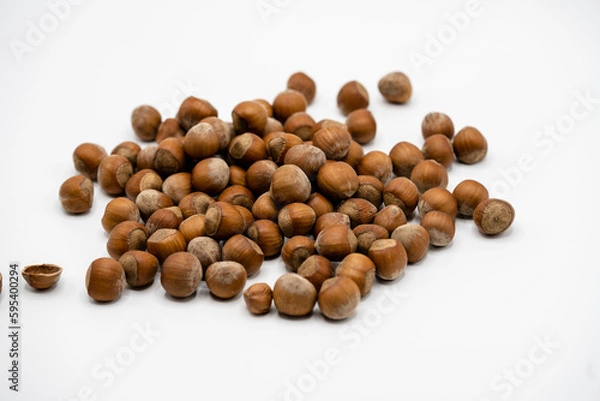 Fototapeta Pile of hazelnuts in a shell on white background