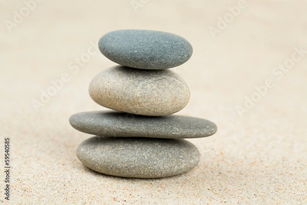 Fototapeta stone pyramid on sea sand