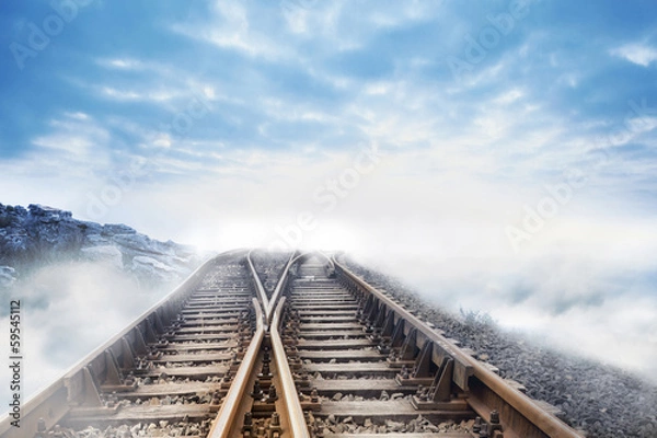 Fototapeta Railway tracks leading to clouds