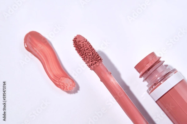 Fototapeta Red lip gloss with applicator and smear.