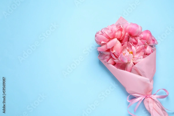 Fototapeta Beautiful bouquet of pink peonies on light turquoise background, top view. Space for text