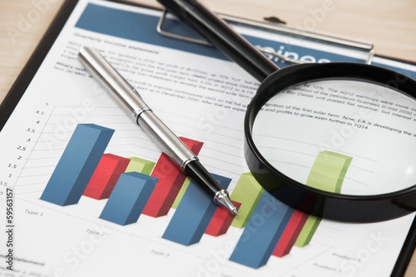 Obraz magnifying glass and pen over graph