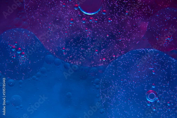 Obraz Circles on the water. Oil stains. Spilled fuel. Oil in water. Gasoline in water. Liquid like oil. Bubbles in the water of different colors and sizes. Red, blue, purple and green.