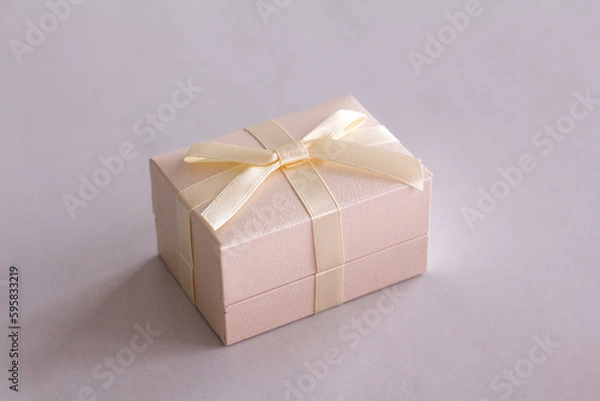 Obraz A light gift box with a satin bow on the table