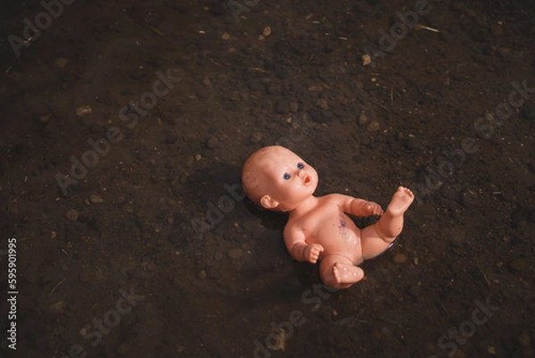 Obraz Damaged doll floating in creek