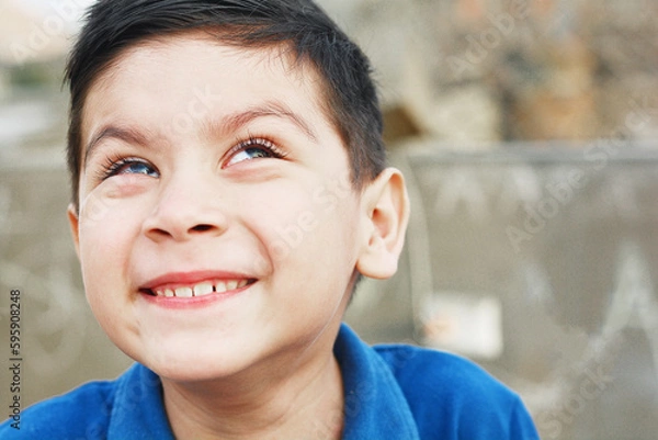 Obraz Sly little latin boy looking up.