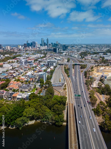 Fototapeta Vertical aerial shot of highway connecting to Perth CBD in Australia
