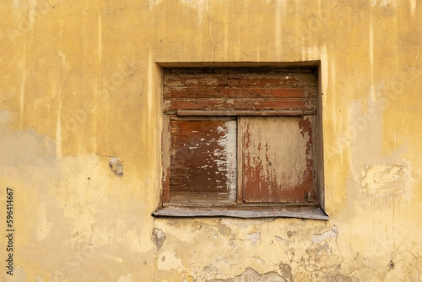 Fototapeta Boarded up window in an old dilapidated stone wall