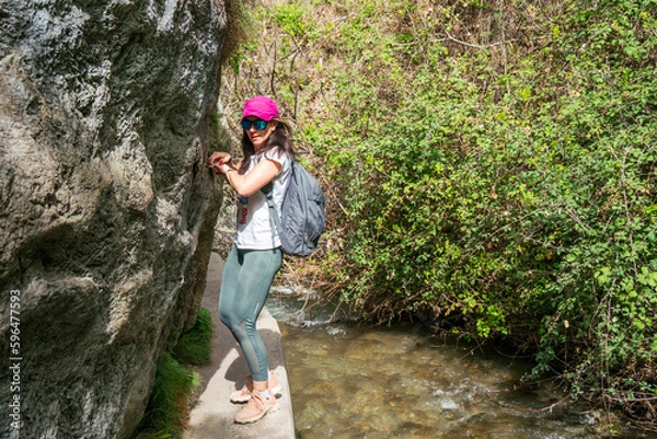 Obraz Woman hiking in Los Cahorros, Granada. Narrow pass along the river.