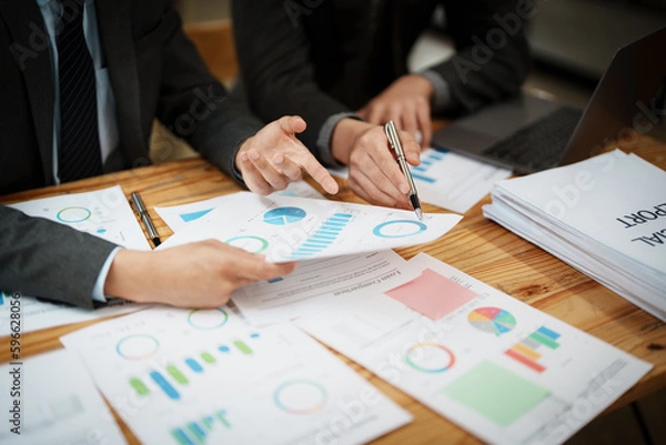 Fototapeta Asian business advisor meeting to analyze and discuss the situation on the financial report in the meeting room.Investment Consultant, Financial , teamwork ,brainstorming ,startup and accounting