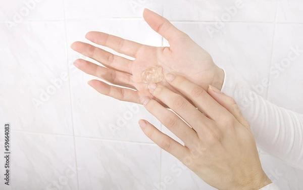 Obraz Hands applying sanitizer gel