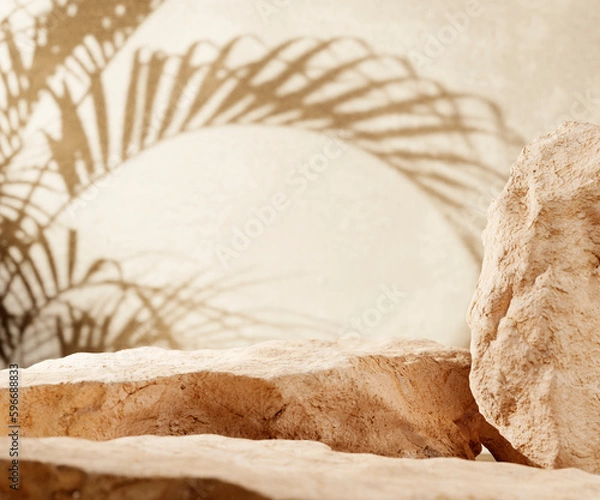Fototapeta Sandstone podium for luxury product placement with palm leaf shadow in background. Natural stone material scene. Minimal luxury aesthetic.