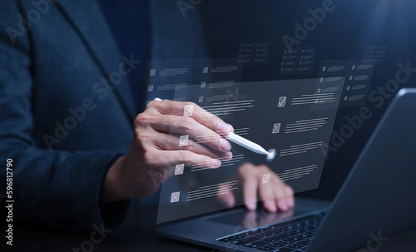 Fototapeta Businessman using laptop computer. doing online checklist survey, filling out digital form checklist, take an assessment, questionnaire, evaluation, online survey and exam. Business performance,