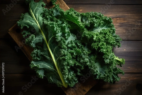 Fototapeta Raw kale leaves of great quality in the corner of a wooden bottom right.