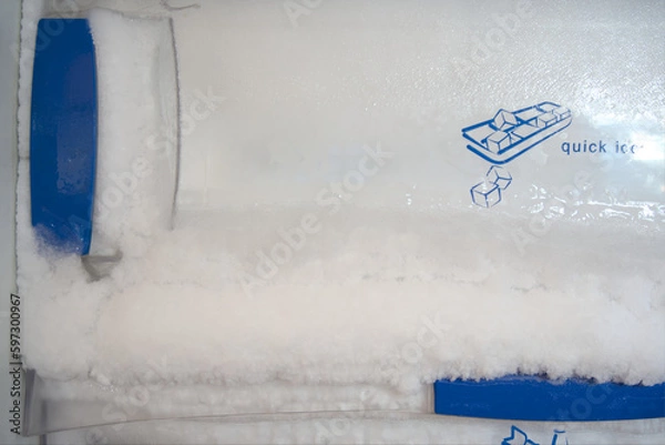 Obraz Frost build up in freezer. Harden ice pushing out of freezer door.