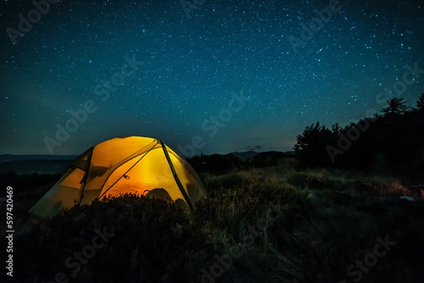 Obraz Glowing camping tent in the mountain forest under a starry sky