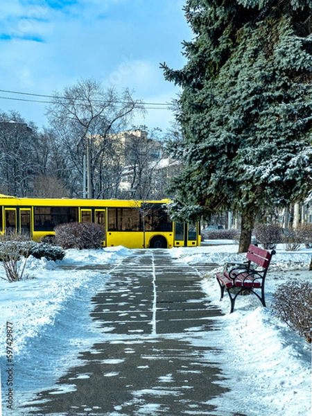 Fototapeta Snowy city scenes: close-up of a passenger bus in winter