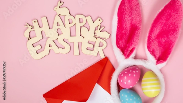 Obraz colored easter eggs and rabbit ears and envelope and blank for text on pink background easter minimal flat lay top view