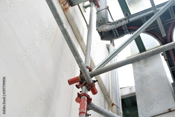 Obraz Scaffolding pipe clamp. Steel scaffolding and mounting parts for strength in construction sites . Close-up and select focus	
