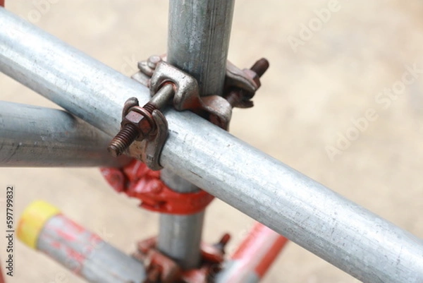 Obraz Scaffolding pipe clamp. Steel scaffolding and mounting parts for strength in construction sites . Close-up and select focus	