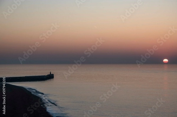 Obraz A dawn light behind Folkestone Harbour Arm