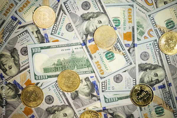 Obraz Online business concept. Golden Bitcoin lies on the banknotes.