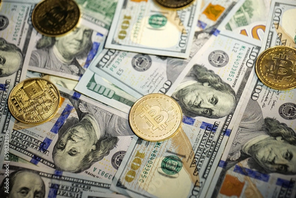 Obraz Online business concept. Golden Bitcoin lies on the banknotes.