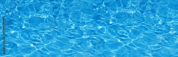 Obraz Transparent blue colored clear water surface texture with splashes.  Water background, ripple and flow with waves. Blue water shinning. Sea, ocean surface. Overhead top view. Flat lay design.