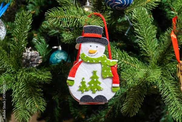 Fototapeta Russia. Kronstadt. January 19, 2023. A festive decoration is a toy in the form of a snowman bag on a Christmas tree.