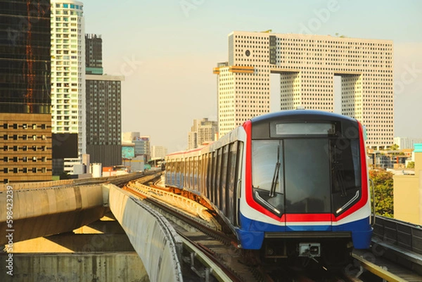 Fototapeta BTS Sky Train is running in downtown of Bangkok.  Sky train is fastest transport mode in Bangkok
