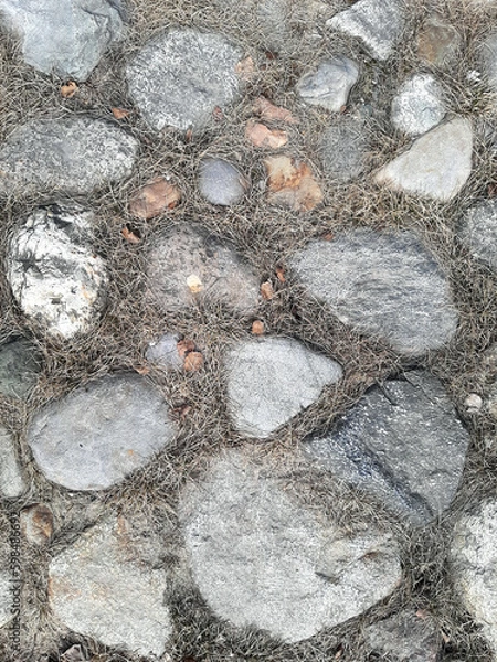 Fototapeta Top view of a fragment of a dirt road. Rubble stones of different fractions on the ground. Abstract natural textured background. Drainage layer.