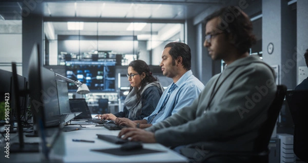 Obraz Team of Talented Young Indian Professionals Working in a Technological Research and Development Agency. Computer Screens with Software Code and Technical Neural Network Diagrams