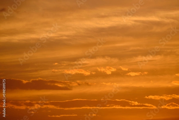 Fototapeta Clouds yellow sky background during sunset.