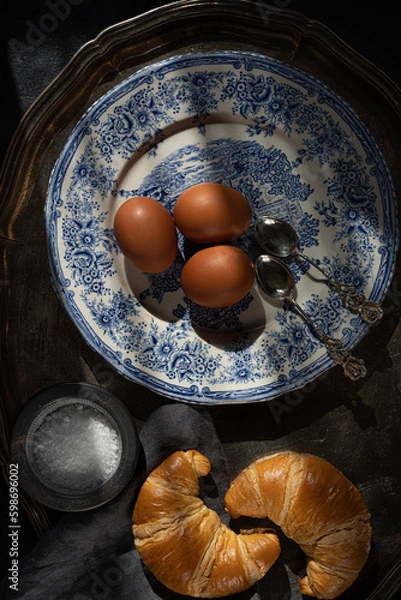 Obraz Boiled,eggs, croissants. Vintage tableware. Sunlit rustic breakfast table. Flat lay composition.