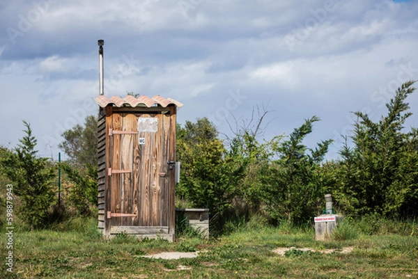 Fototapeta Log cabin toilet hat on a campground in natural environment