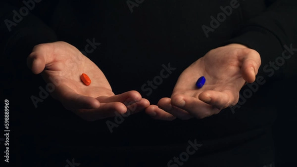 Obraz Studio shot hands show red pill and blue pill isolated on black background. Concept of making right choice.