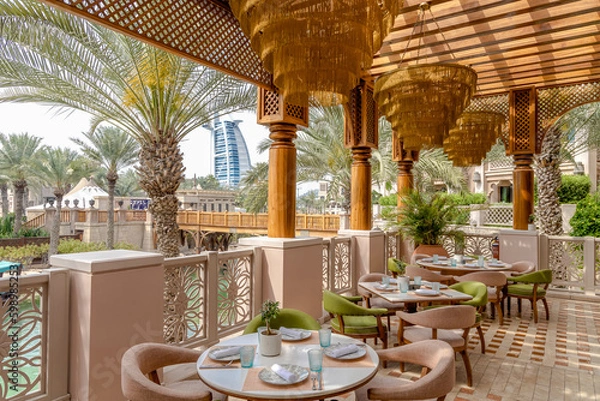Obraz A restaurant with a view of the Burj al Arab in Dubai.
