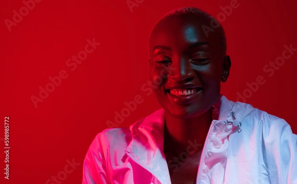 Fototapeta Think positively. Red filtered shot of a beautiful young woman posing in the studio.