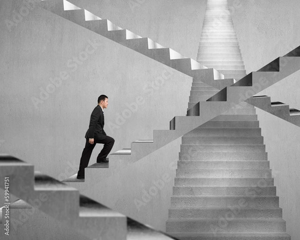 Obraz Businessman climbing on concrete stair maze